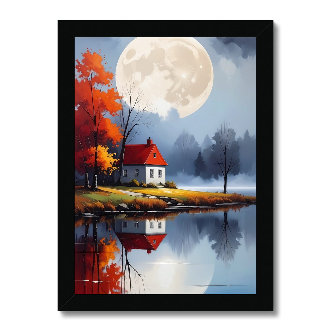 Framed artwork of a house by a lake with a full moon and autumn trees.