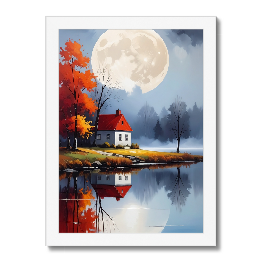 Framed artwork of a house by a lake with a full moon and autumn trees.