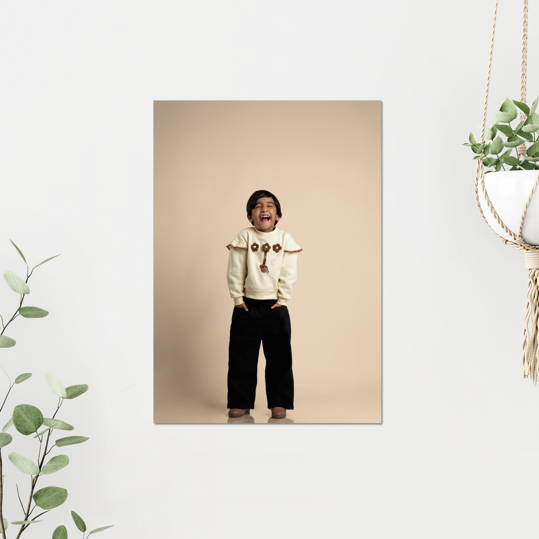 Acrylic Photo print of a child in a white sweater with red patterns on a beige background