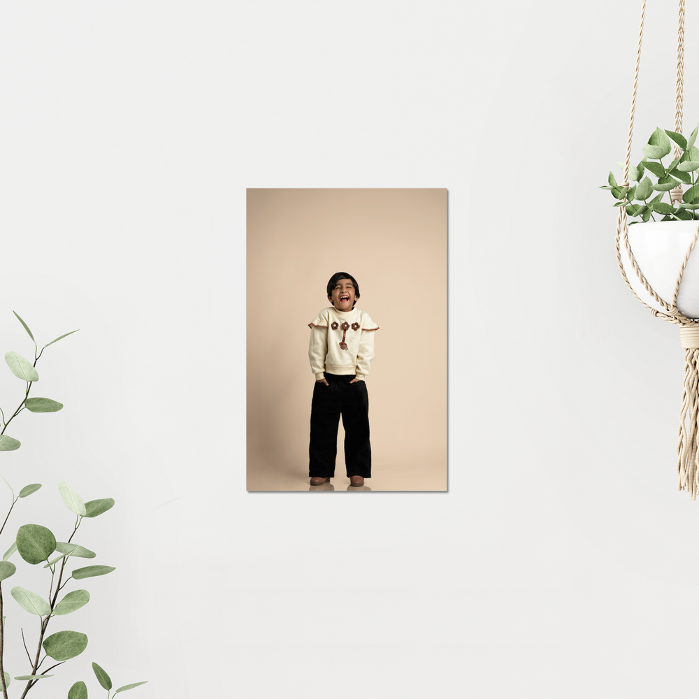 A kid standing against a beige background with decorative elements on a light gray wall printed on Acrylic by printlagoon.