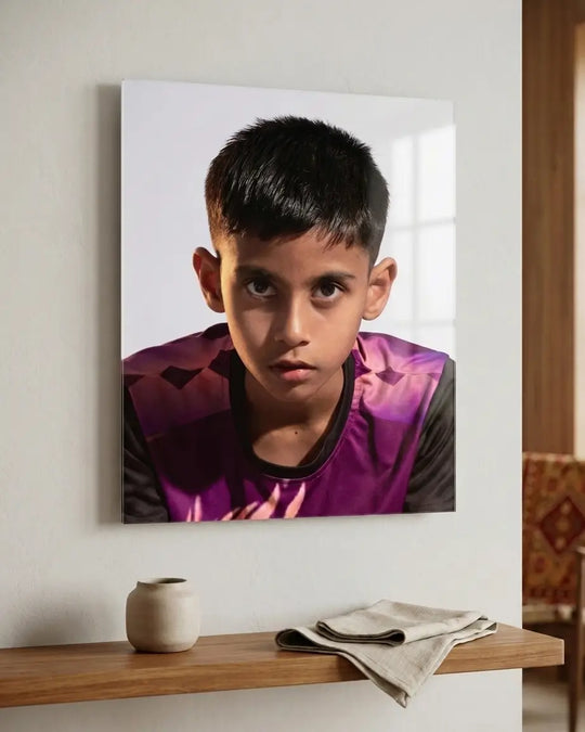 Acrylic print of a young boy in a purple and black sports jersey hanging on a wall.