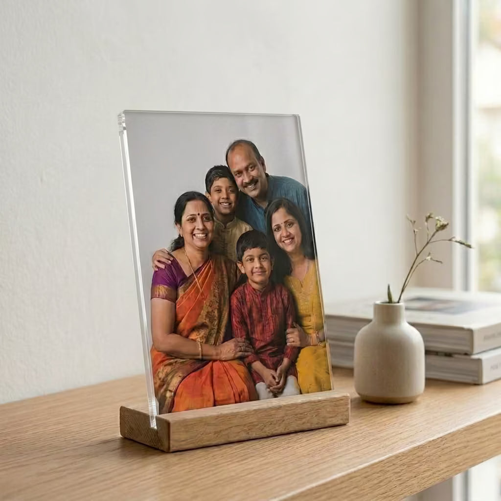 Custom acrylic photo frame with wooden base featuring a family portrait in a minimalist home setting.