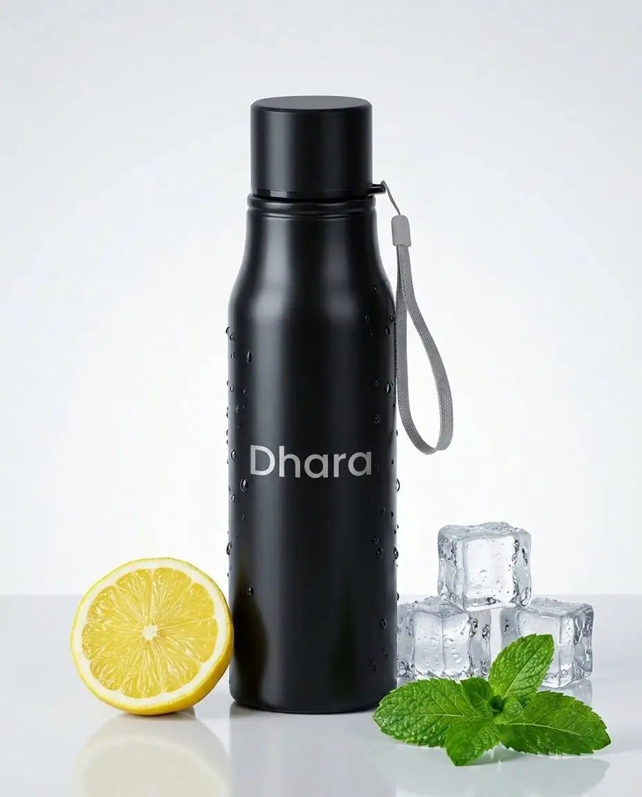 A matte black insulated water bottle with a gray wrist strap and the brand name 'Dhara' printed on the front, styled on a white surface with a halved lemon, mint leaves, and ice cubes against a light gray background.