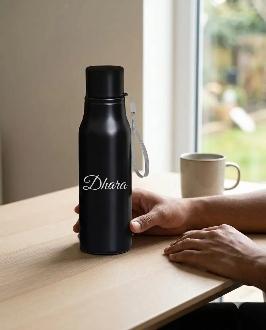 A matte black insulated water bottle with a white script name &